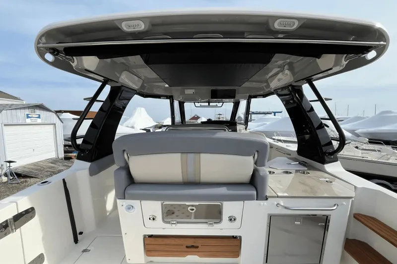 Yacht Photos Pics 2025 Boston Whaler 350 Realm boat interior with seating and storage compartments.