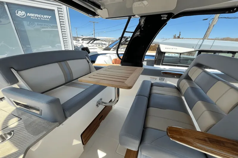  Yacht Photos Pics 2025 Boston Whaler 350 Realm interior with sleek seating and wooden table.