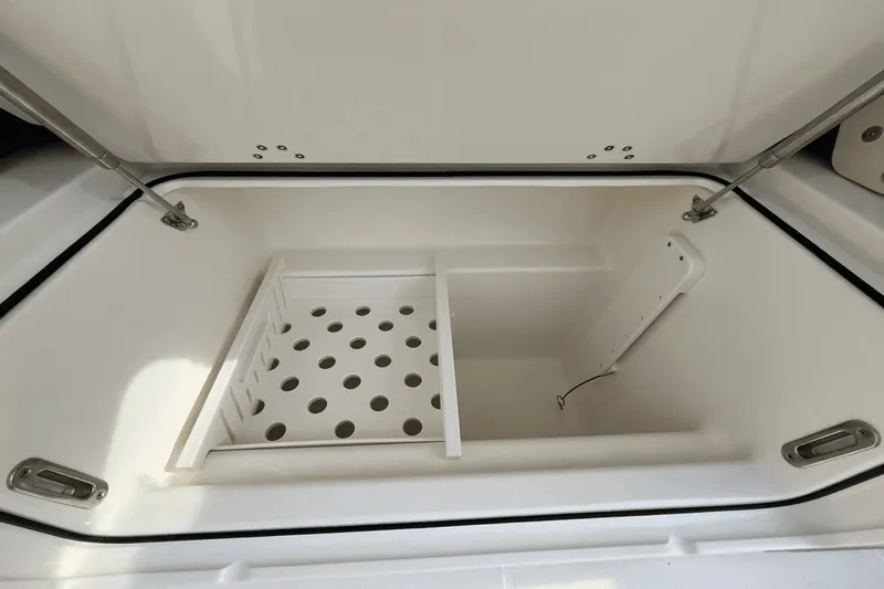  Yacht Photos Pics Open storage compartment on 2025 Boston Whaler 350 Realm boat, featuring organized interior space.