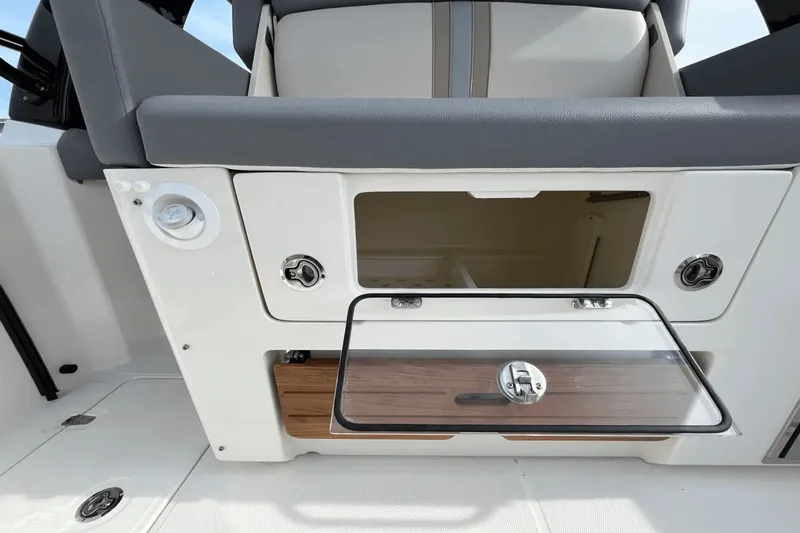  Yacht Photos Pics 2025 Boston Whaler 350 Realm storage compartment with open hatch and seating.