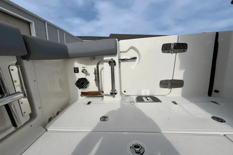  Yacht Photos Pics 2025 Boston Whaler 350 Realm boat interior, featuring seating and storage compartments.