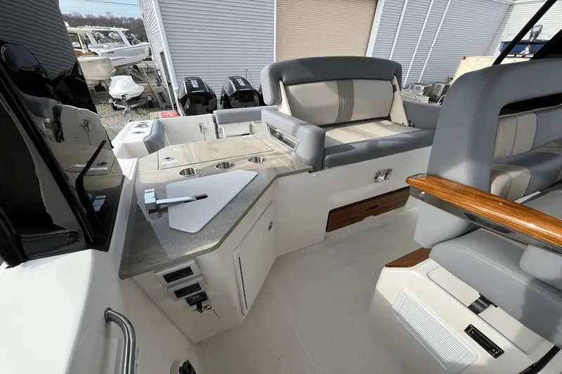  Yacht Photos Pics 2025 Boston Whaler 350 Realm interior with seating and sleek design features.