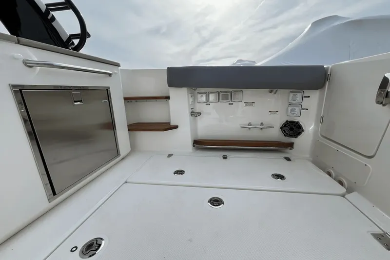  Yacht Photos Pics 2025 Boston Whaler 350 Realm boat interior with storage and seating area.