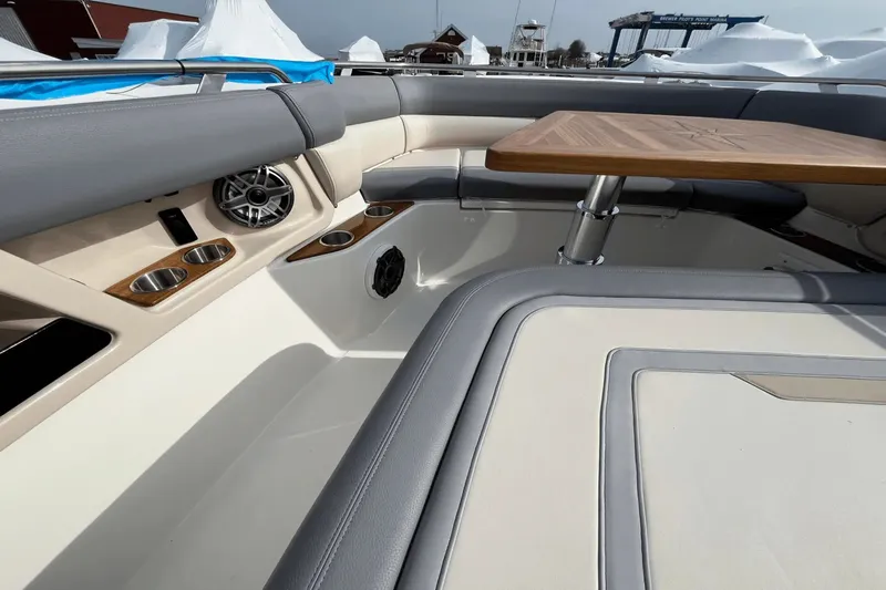  Yacht Photos Pics 2025 Boston Whaler 350 Realm interior with seating, table, and cup holders.