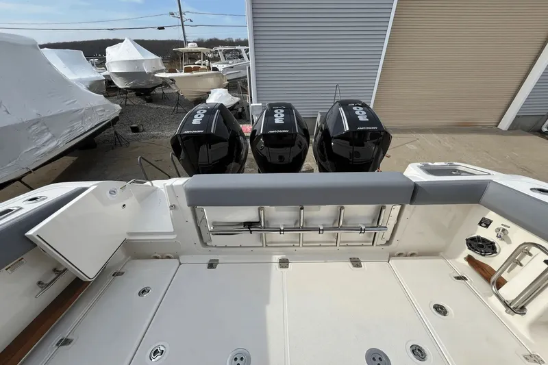  Yacht Photos Pics 2025 Boston Whaler 350 Realm with triple Mercury outboard engines, docked at a marina.
