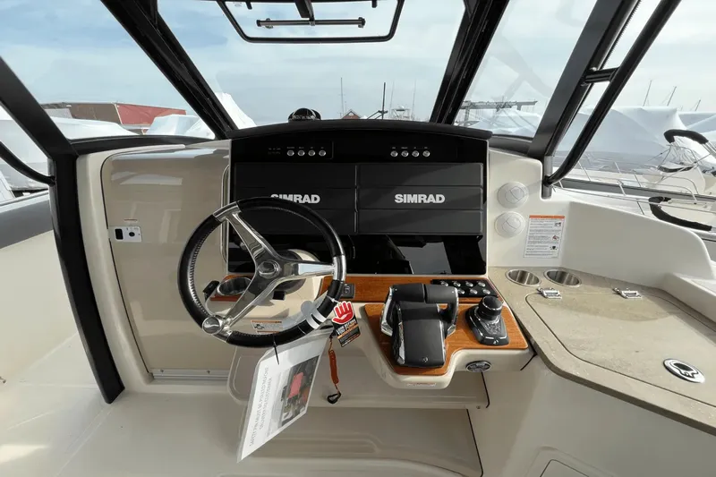 Yacht Photos Pics 2025 Boston Whaler 350 Realm helm with Simrad electronics and modern steering wheel.