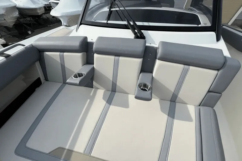  Yacht Photos Pics 2025 Boston Whaler 350 Realm boat seating area with cup holders and sleek design.