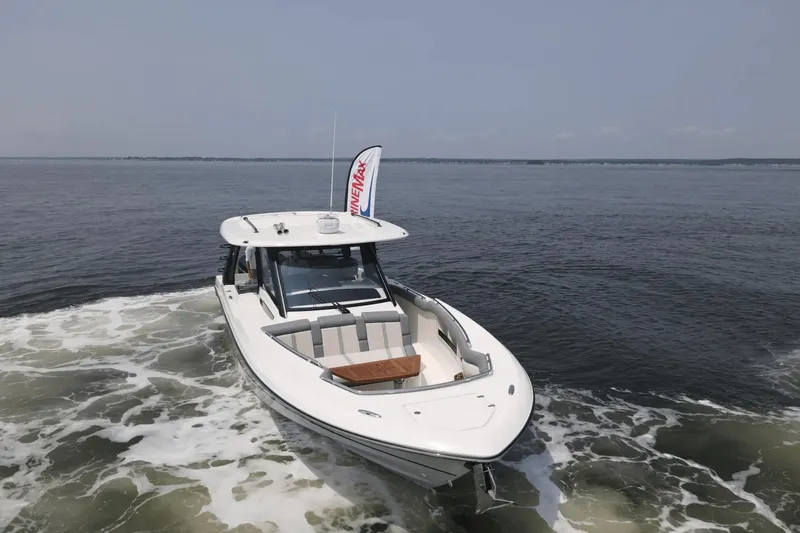  Yacht Photos Pics 2025 Boston Whaler 350 Realm cruising on open water, showcasing sleek design and performance.