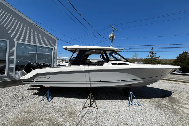 Yacht Photos Pics 2025 Boston Whaler 350 Realm boat displayed outdoors on stands.