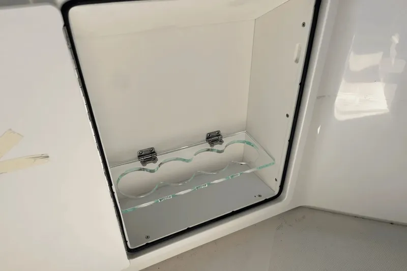  Yacht Photos Pics Storage compartment on 2025 Boston Whaler 350 Realm boat, featuring a glass shelf.