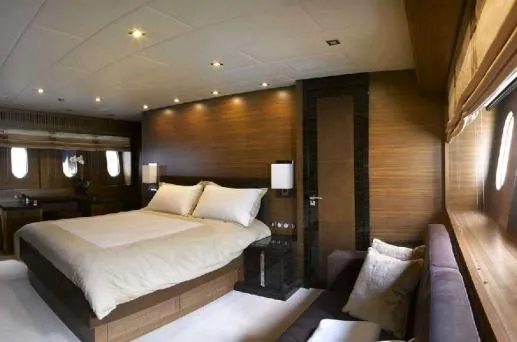 Eclat Yacht Photos Pics Luxurious bedroom interior on 2008 Arno Leopard 31 yacht, featuring elegant wood paneling and modern lighting.