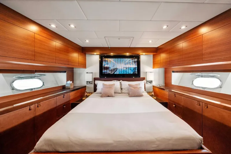 Eclat Yacht Photos Pics Luxurious bedroom interior of 2008 Arno Leopard 31 yacht with elegant wood finishes.