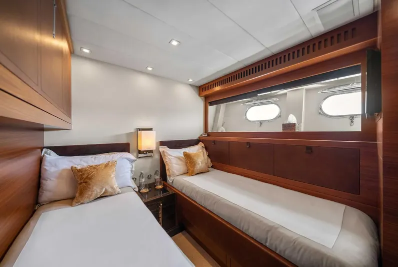 Eclat Yacht Photos Pics Luxurious twin cabin on 2008 Arno Leopard 31 yacht with elegant wood finishes.