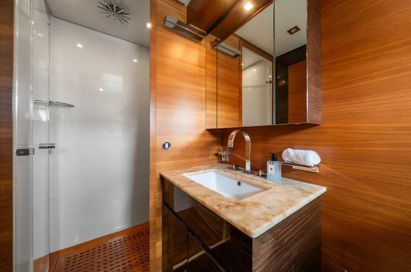 Eclat Yacht Photos Pics Luxurious yacht bathroom with wooden accents, modern sink, and glass shower in Arno Leopard 31, 2008.