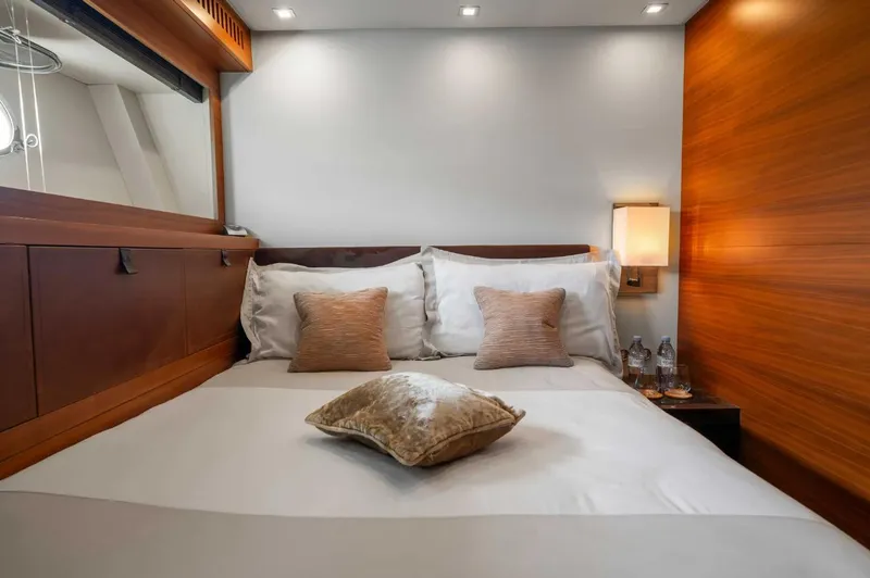 Eclat Yacht Photos Pics Luxurious bedroom interior on 2008 Arno Leopard 31 yacht, featuring elegant wood paneling and plush bedding.