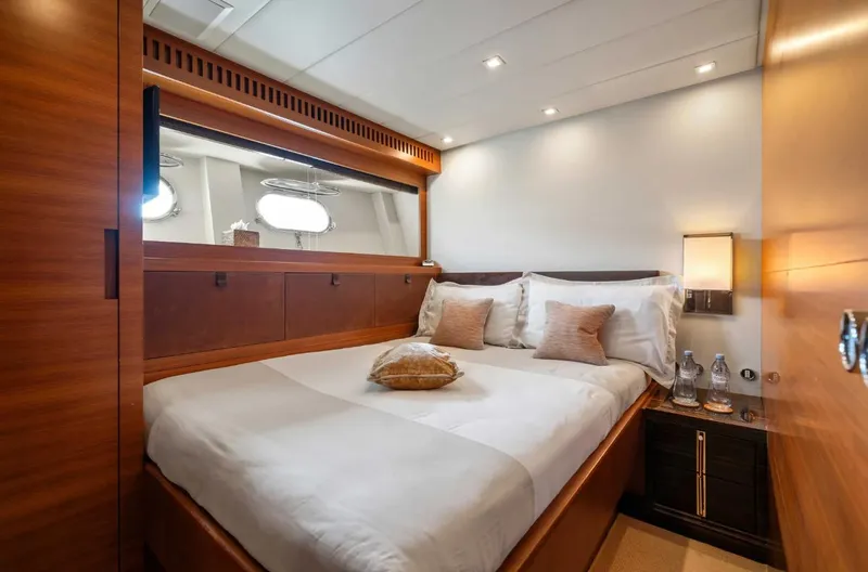 Eclat Yacht Photos Pics Luxurious bedroom interior on 2008 Arno Leopard 31 yacht with elegant wood finishes.