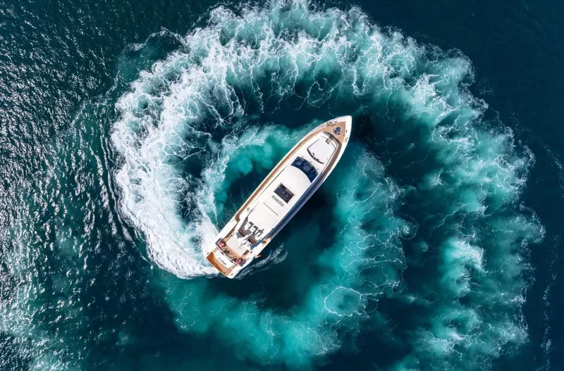 Eclat Yacht Photos Pics Aerial view of 2008 Arno Leopard 31 yacht creating circular waves in blue ocean.