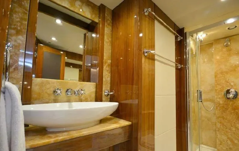 Yacht Photos Pics Luxurious bathroom on a 2010 Sunseeker 30 Metre Yacht with elegant fixtures and wood accents.