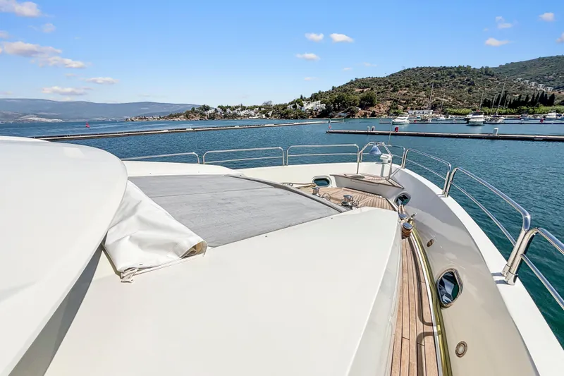  Yacht Photos Pics Sunseeker 30 Metre Yacht 2010 on calm waters with scenic coastal backdrop.