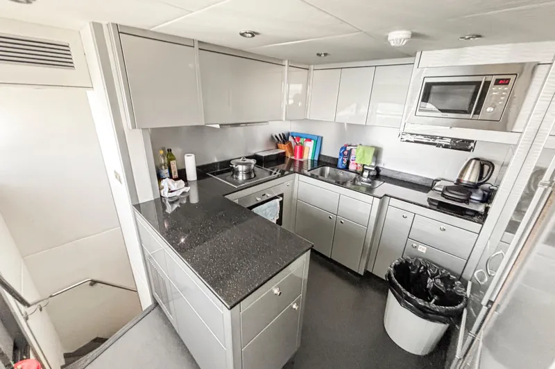  Yacht Photos Pics Modern kitchen interior on 2010 Sunseeker 30 Metre Yacht, featuring sleek cabinetry and appliances.