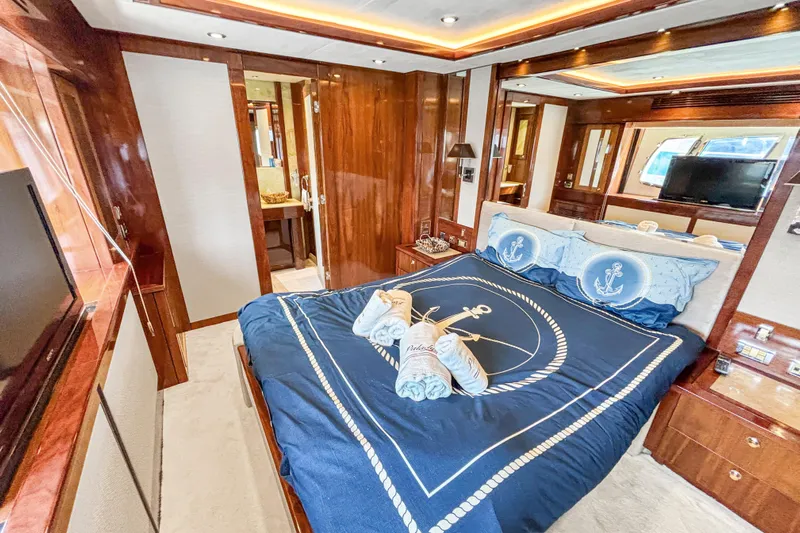  Yacht Photos Pics Luxurious Sunseeker 30 Metre Yacht bedroom with nautical-themed bedding, elegant wood finishes, and ambient lighting.