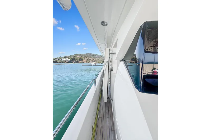  Yacht Photos Pics Side view of 2010 Sunseeker 30 Metre Yacht on calm water, clear sky.