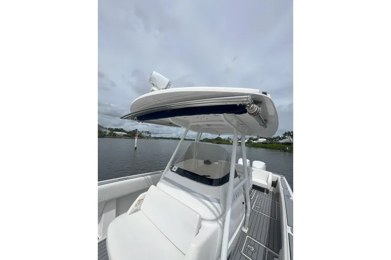  Yacht Photos Pics 2011 Intrepid 323 Cuddy boat on calm water, showcasing sleek design and spacious deck.