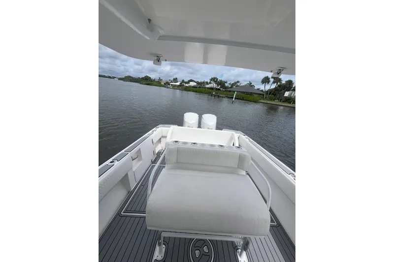  Yacht Photos Pics 2011 Intrepid 323 Cuddy boat interior with seating, overlooking calm waters.