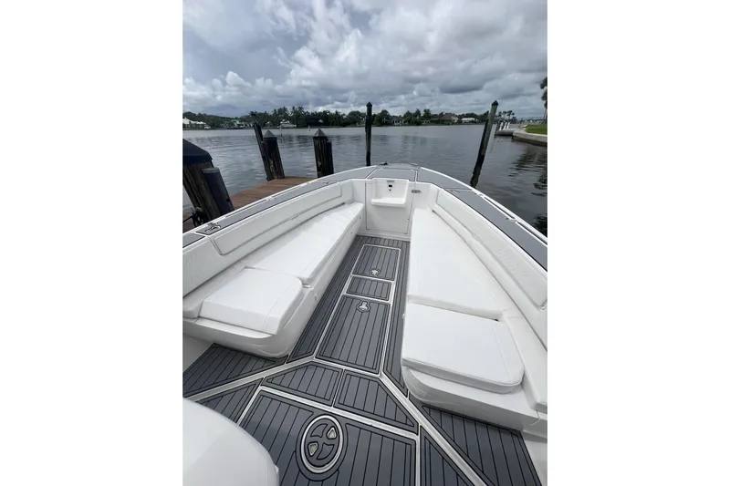  Yacht Photos Pics 2011 Intrepid 323 Cuddy boat with sleek seating and waterfront view.