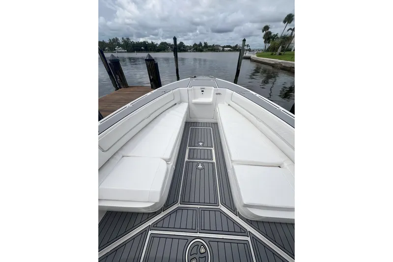  Yacht Photos Pics 2011 Intrepid 323 Cuddy boat interior with white seating and sleek deck design.