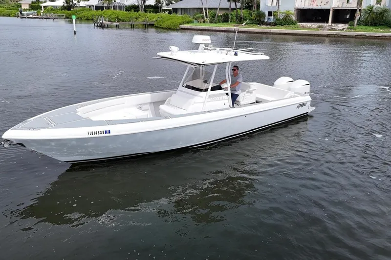  Yacht Photos Pics 2011 Intrepid 323 Cuddy boat cruising on a calm waterway.