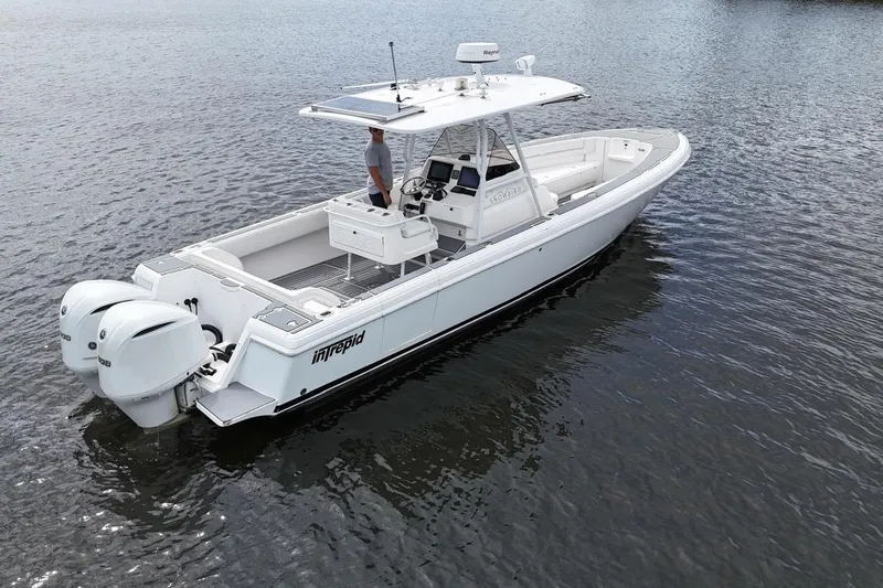  Yacht Photos Pics 2011 Intrepid 323 Cuddy boat on water, featuring dual outboard engines.