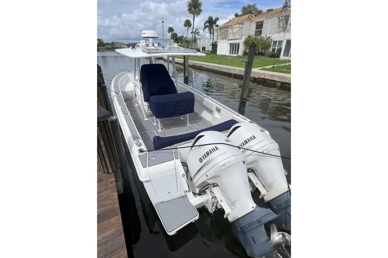  Yacht Photos Pics 2011 Intrepid 323 Cuddy boat with Yamaha engines docked by waterfront homes.