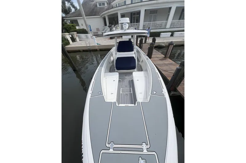  Yacht Photos Pics 2011 Intrepid 323 Cuddy boat docked at a marina, showcasing sleek design and spacious deck.