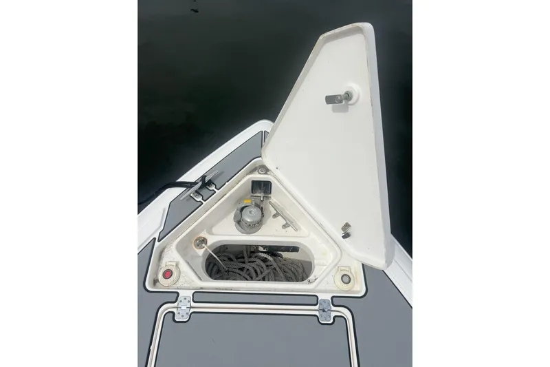  Yacht Photos Pics Open anchor compartment on 2011 Intrepid 323 Cuddy boat, showing rope and winch.