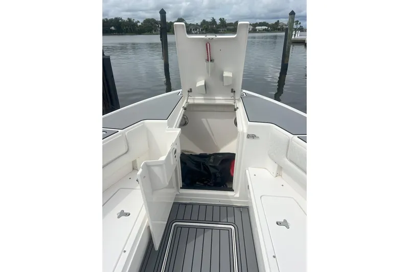  Yacht Photos Pics 2011 Intrepid 323 Cuddy boat interior with open storage compartment, dockside view.