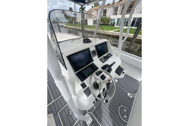  Yacht Photos Pics Helm of 2011 Intrepid 323 Cuddy boat with modern controls and navigation screens.