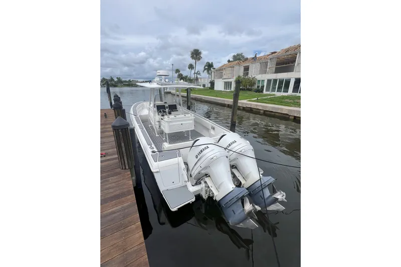  Yacht Photos Pics 2011 Intrepid 323 Cuddy boat docked with twin Yamaha engines.