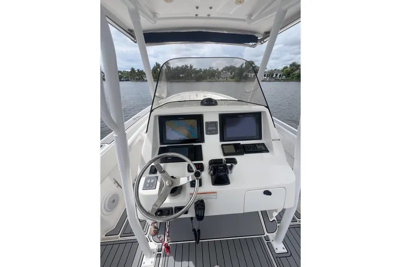  Yacht Photos Pics 2011 Intrepid 323 Cuddy boat helm with navigation screens and steering wheel.