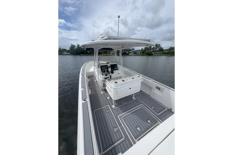  Yacht Photos Pics 2011 Intrepid 323 Cuddy boat with sleek deck design on calm water.
