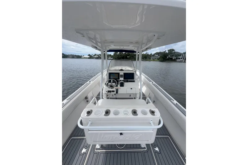  Yacht Photos Pics 2011 Intrepid 323 Cuddy boat interior with helm, steering wheel, and navigation screens.