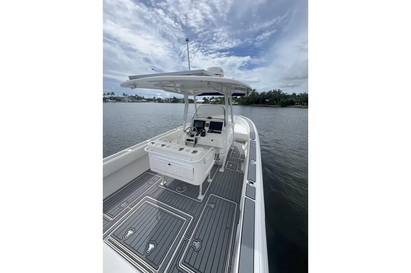  Yacht Photos Pics 2011 Intrepid 323 Cuddy boat with sleek deck design on calm waters.
