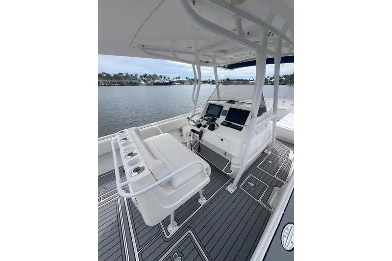  Yacht Photos Pics 2011 Intrepid 323 Cuddy boat interior with helm, seating, and water view.