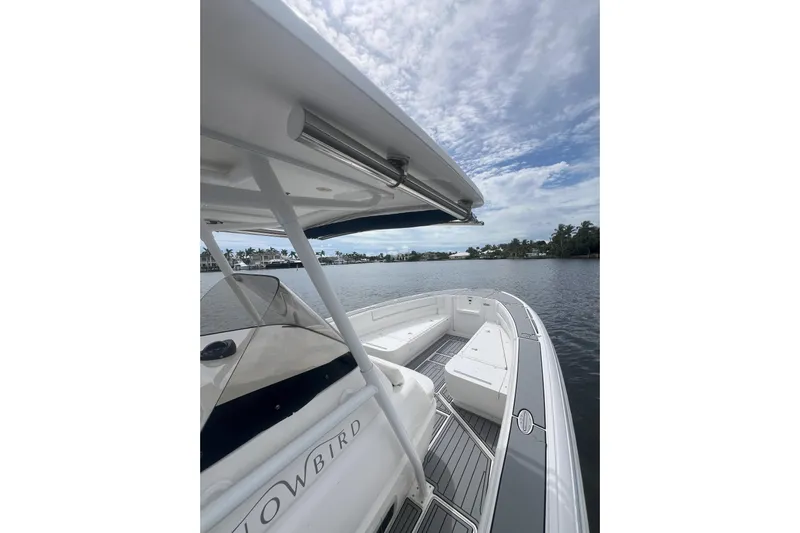  Yacht Photos Pics 2011 Intrepid 323 Cuddy boat on calm water under cloudy sky.