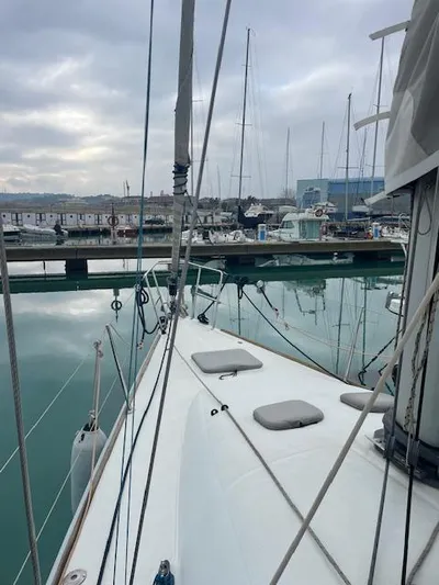  Yacht Photos Pics 2008 Beneteau First 40.7 sailboat docked in a marina under cloudy skies.