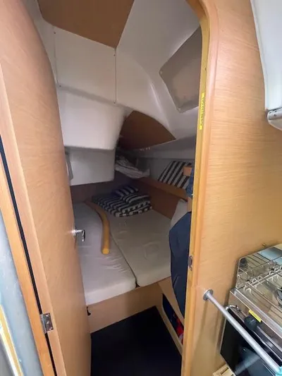  Yacht Photos Pics 2008 Beneteau First 40.7 cabin interior with cozy bedding and wooden finish.