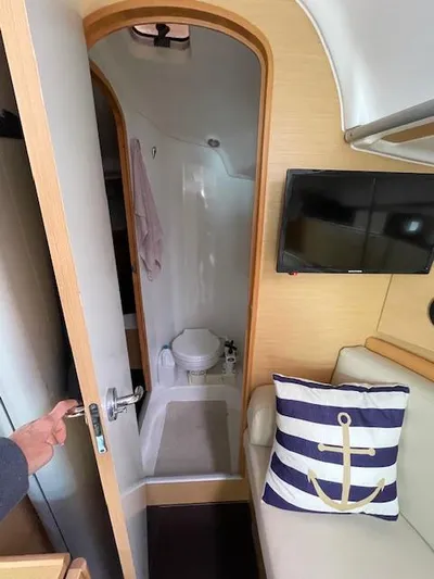  Yacht Photos Pics Interior of 2008 Beneteau First 40.7 yacht with bathroom, TV, and nautical-themed pillow.