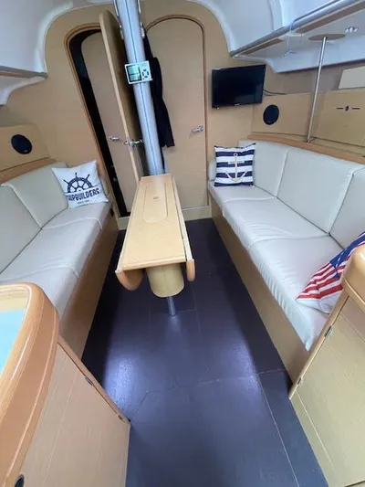  Yacht Photos Pics Interior of 2008 Beneteau First 40.7 sailboat with cozy seating and nautical decor.