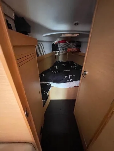  Yacht Photos Pics Cozy cabin interior of 2008 Beneteau First 40.7 sailboat with nautical-themed bedding.