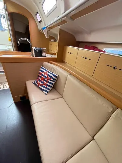  Yacht Photos Pics Interior of 2008 Beneteau First 40.7 yacht with beige seating and nautical decor.
